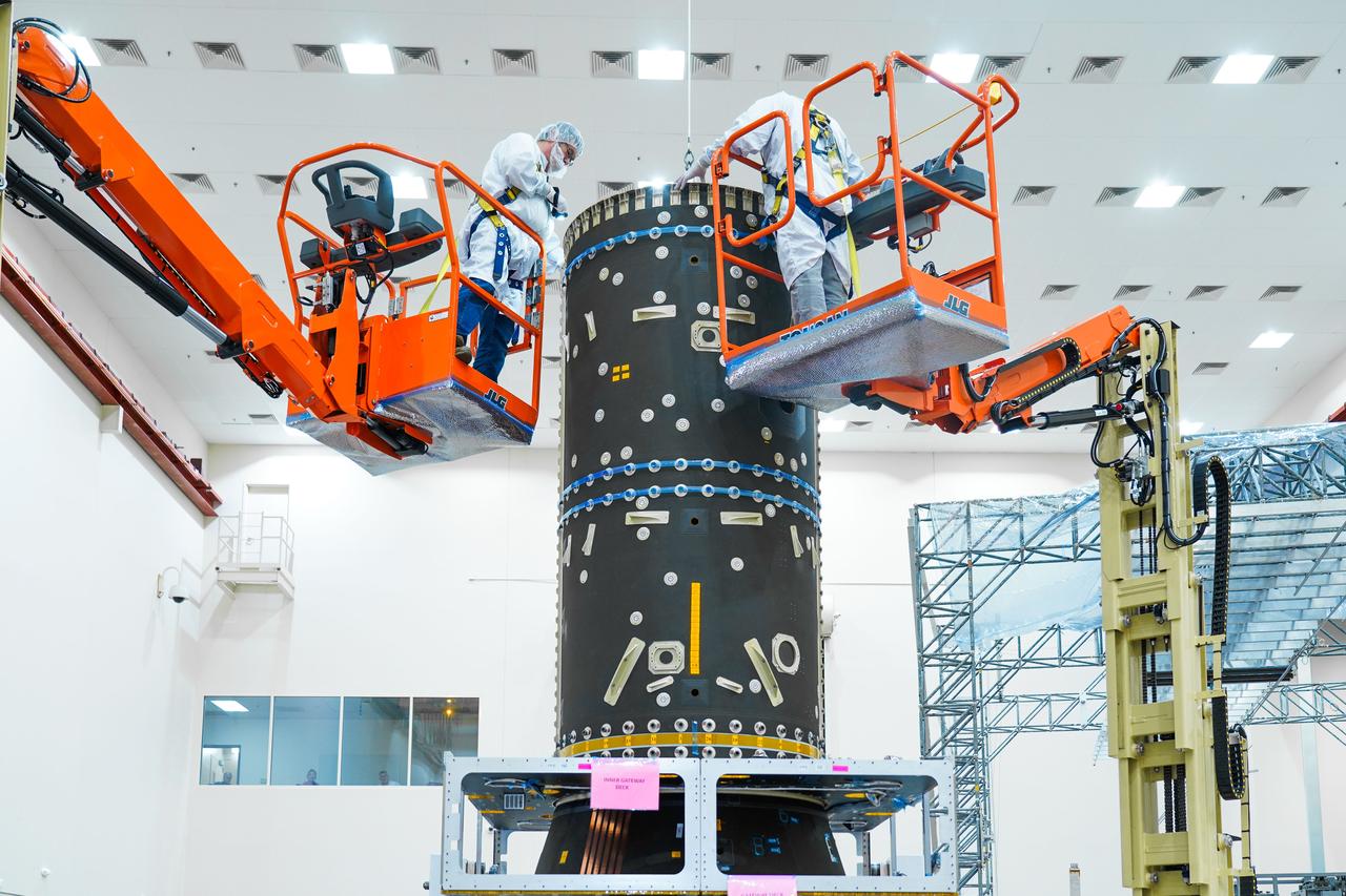 jsc2024e044856 (July 1, 2024) -- Two engineers in cleanroom suits work on the Power and Propulsion Element at Maxar Space Systems in Palo Alto, California. Photo Credit: Maxar Space Systems 
